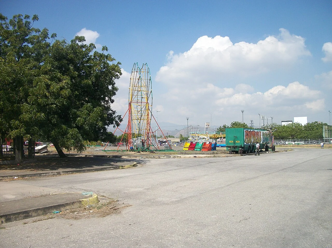 A Valencia roadway and city view provides local context for the article’s caution that climate, roads, and vehicle costs need current inspection.