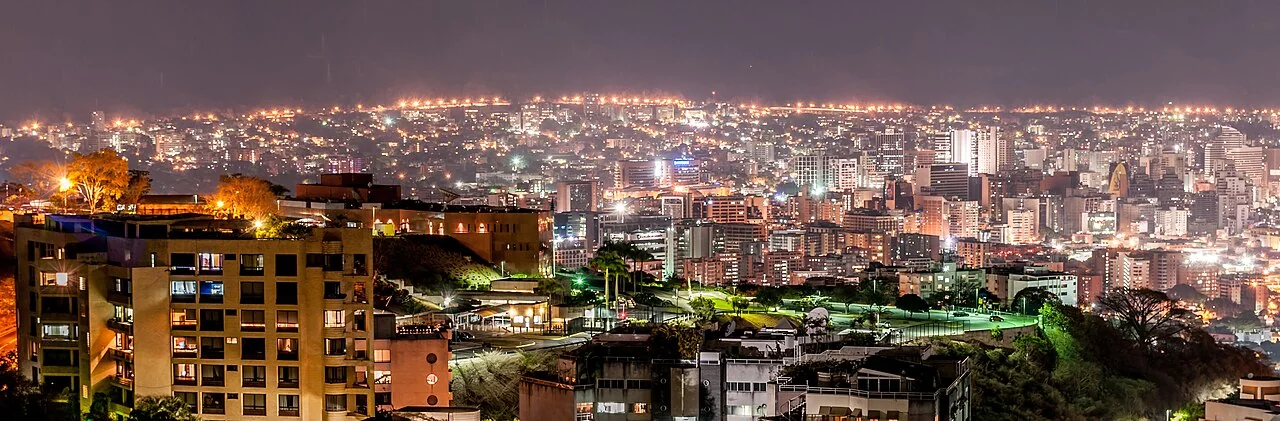 Caracas at night: the capital’s scale and concentration of services are part of the cost comparison, but this skyline is not a price index.