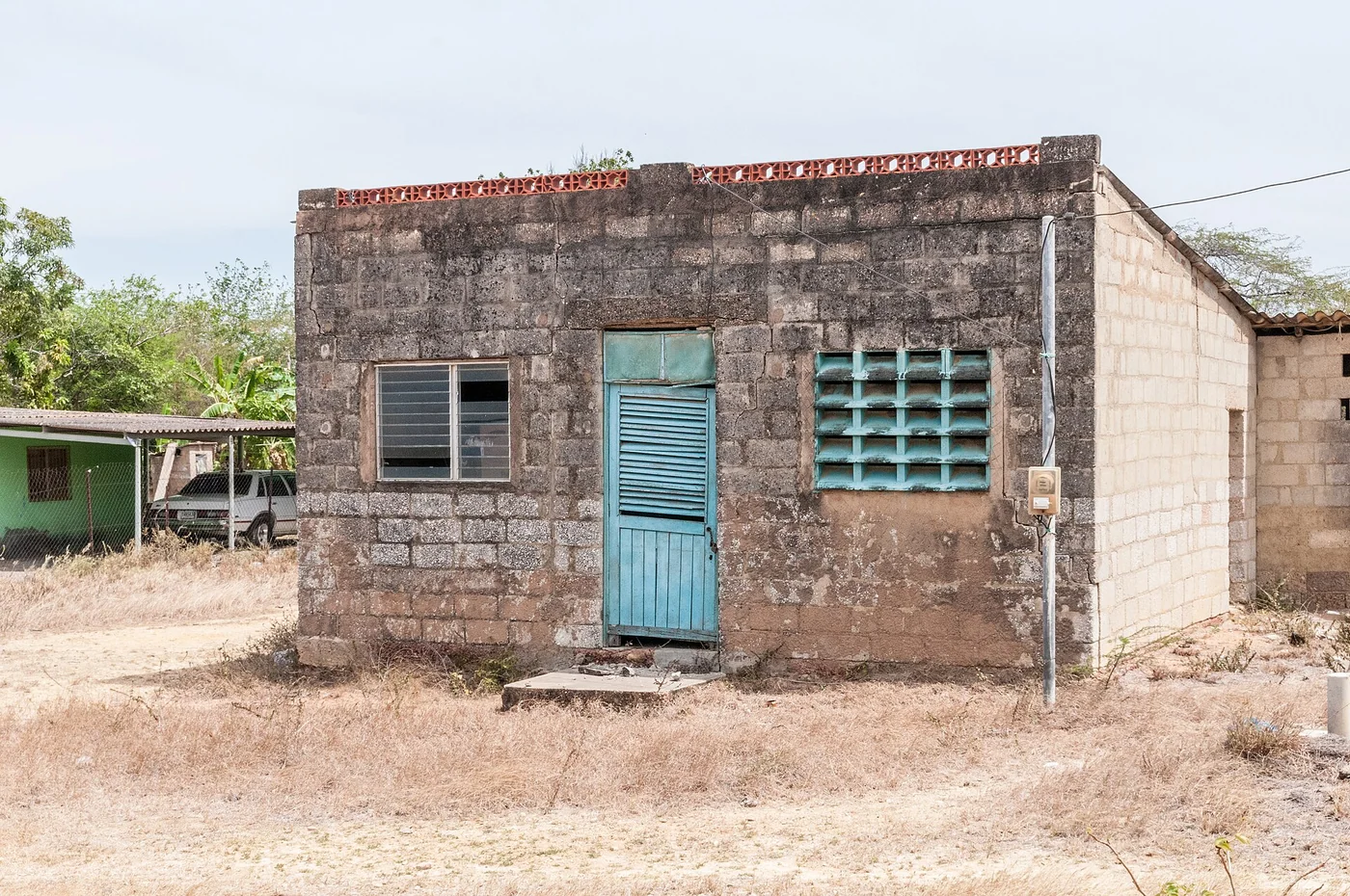 A breeze block house with a blue door. Margarita Island, Nueva Esparta, Venezuela.