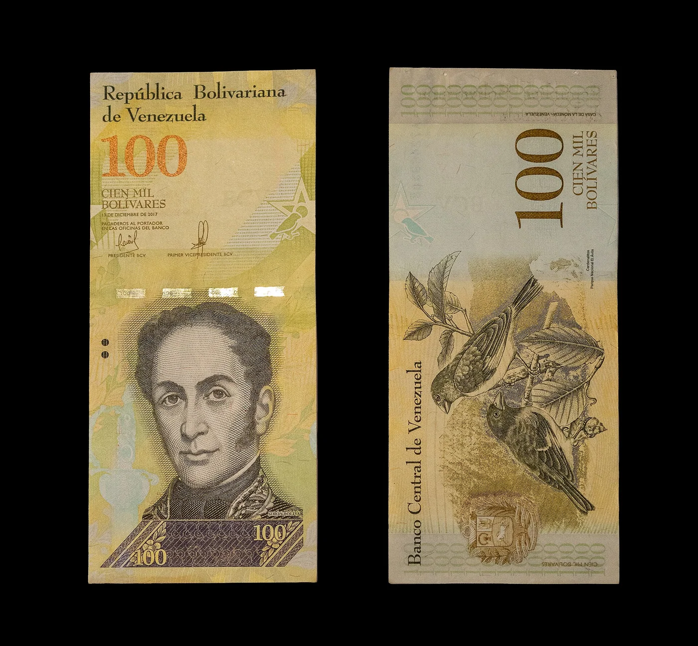 Front and back of a Venezuelan 100,000-bolívar banknote.