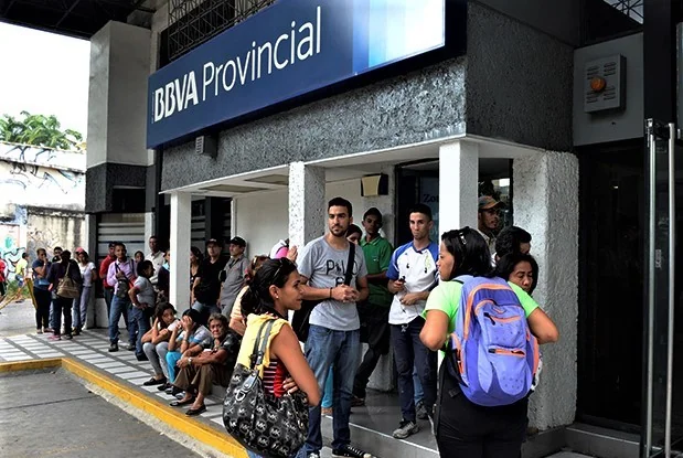 Customers waiting outside a BBVA Provincial branch in Venezuela.