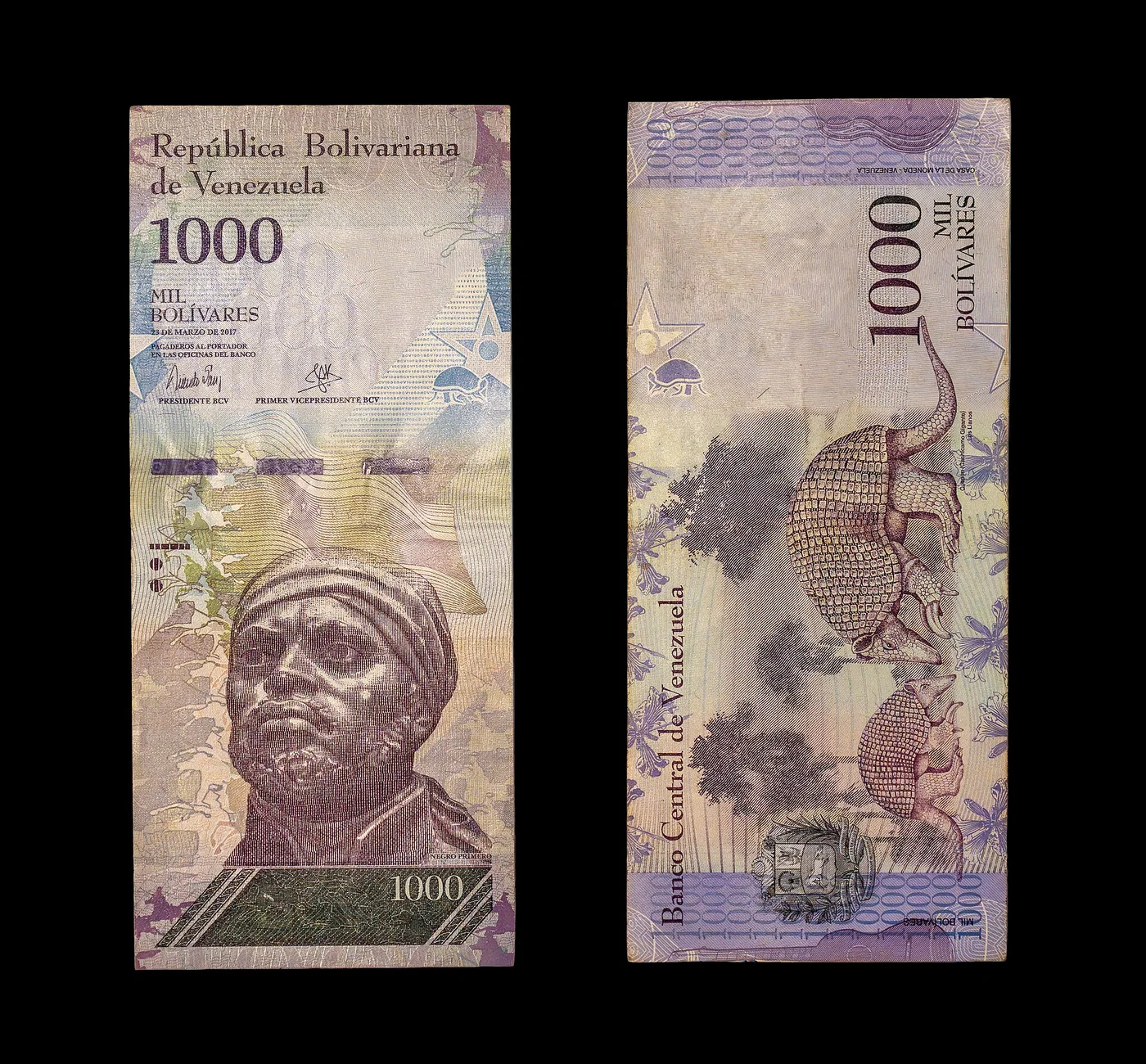 Front and back of a Venezuelan 1,000-bolívar banknote.