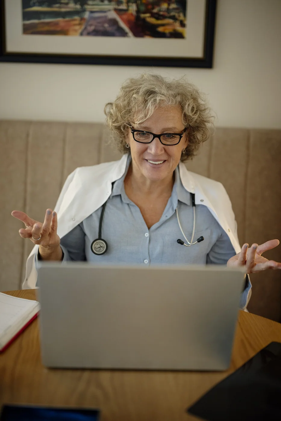 Medical professional conducting an online consultation at a desk