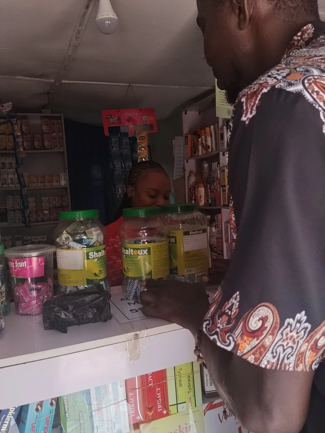 Customer buying medication at a local pharmacy counter
