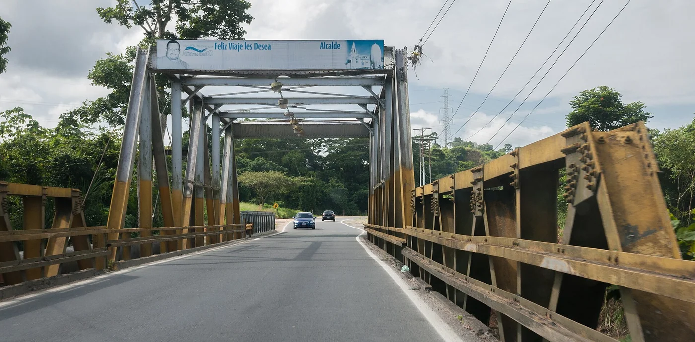 A Venezuelan road bridge is used here to make the infrastructure-verification point concrete; it is not a named ZEE facility.