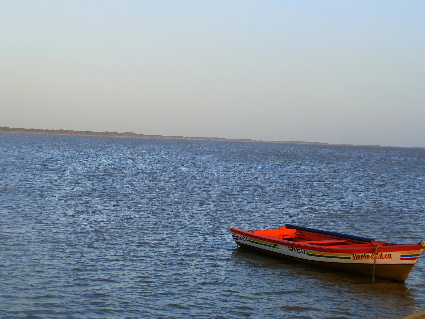 A local canoe scene gives accurate coastal context for the article’s tourism and maritime-activity discussion.