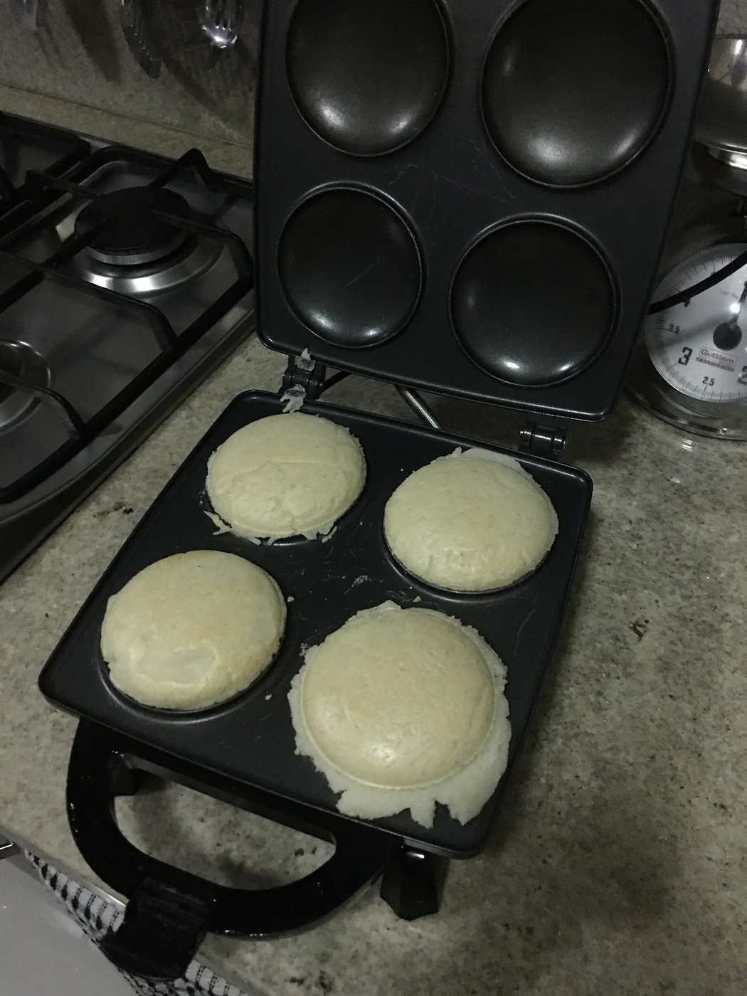 Arepas ready to be served after having been made in an arepa maker machine (Tosty Arepa by Oster). These were made by adding a teaspoonful of salt to around 200 grams of Harina PAN corn flour, mixing it in warm water, and making ovoid figures of the mixture so they can be molded and cooked in the machine