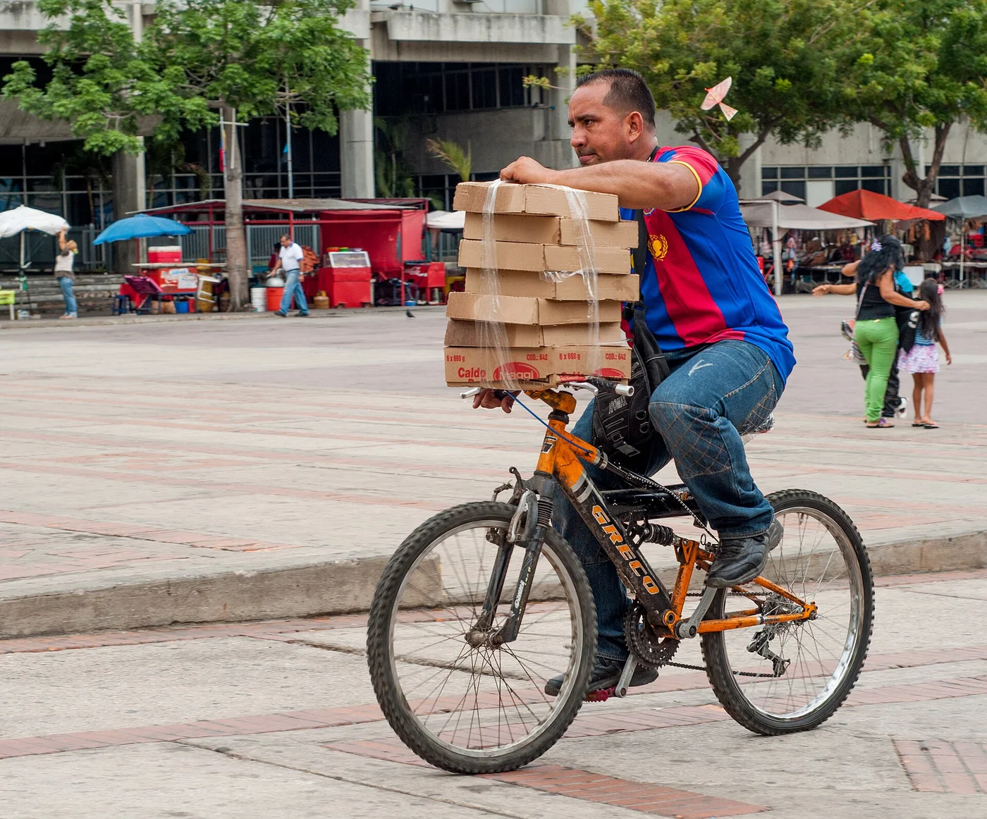 A man carrying boxes by bicycle in Venezuela.